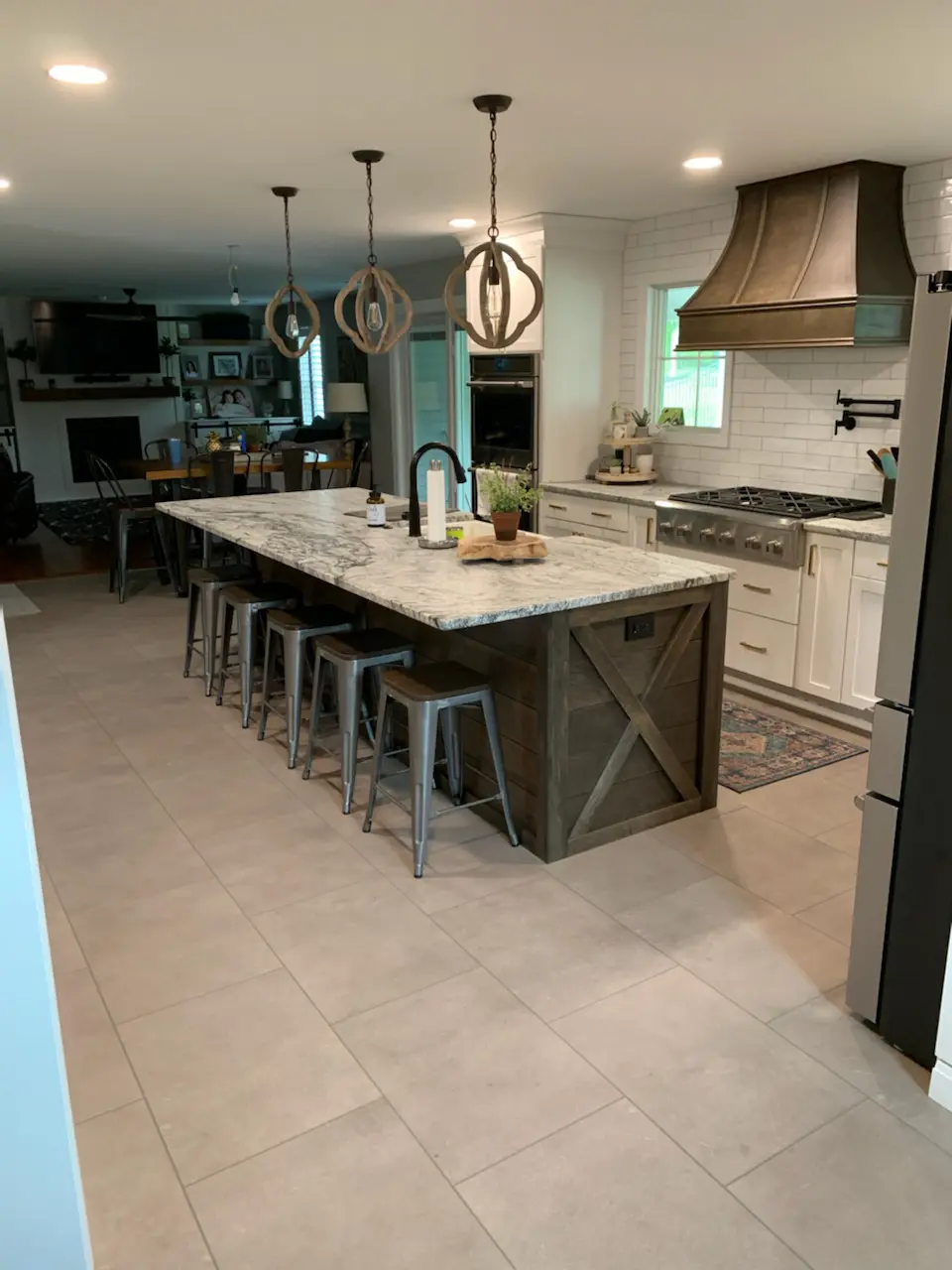 Modern kitchen with island and bar stools.